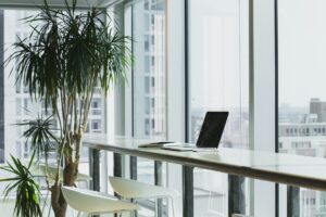 A computer sitting on a desk in an empty office.