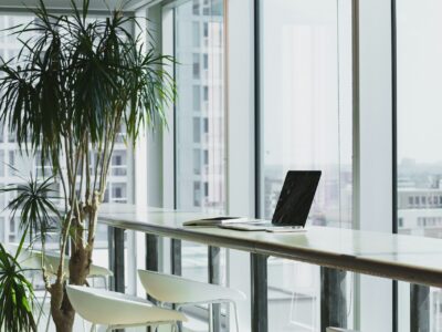 A computer sitting on a desk in an empty office.