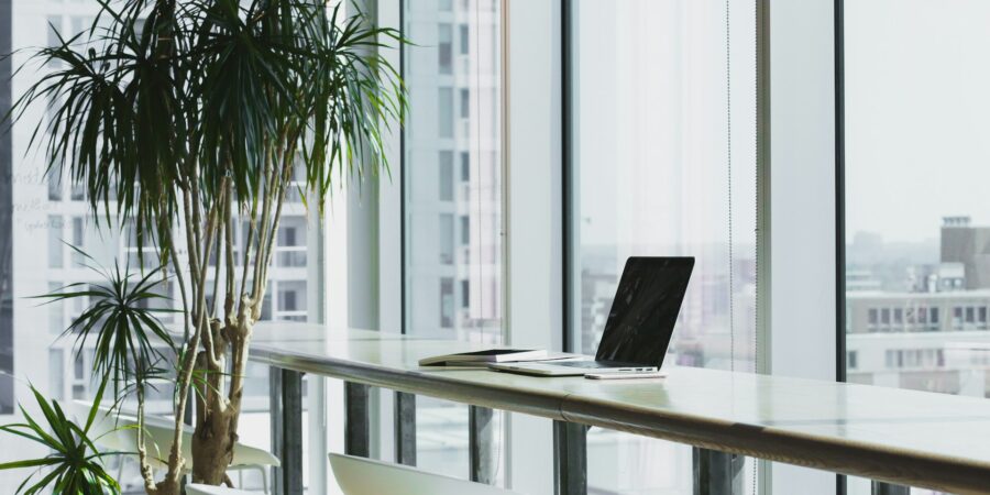 A computer sitting on a desk in an empty office.