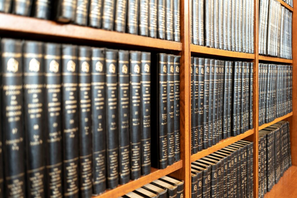 A large collection of legal texts on a bookshelf.