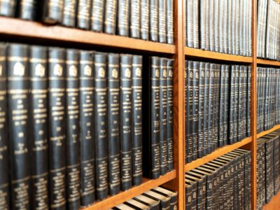 A large collection of legal texts on a bookshelf.