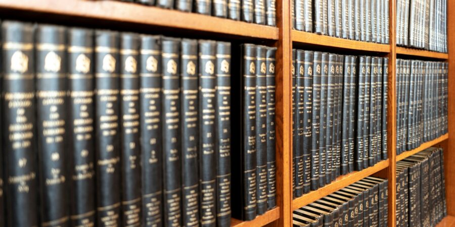 A large collection of legal texts on a bookshelf.