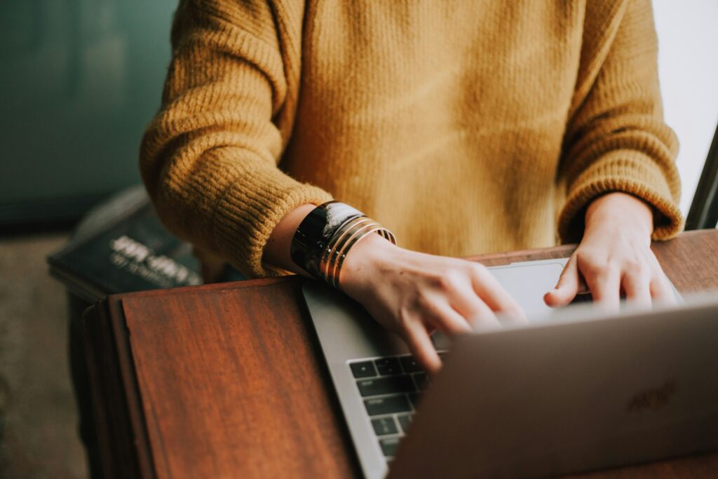 A woman working at a laptop.