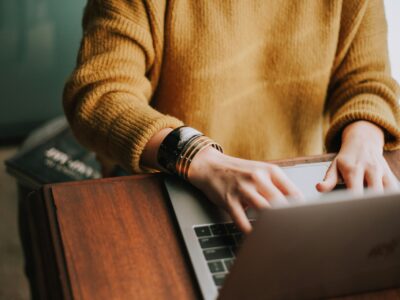 A woman working at a laptop.