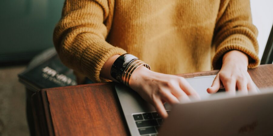 A woman working at a laptop.